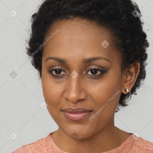 Joyful black young-adult female with short  brown hair and brown eyes