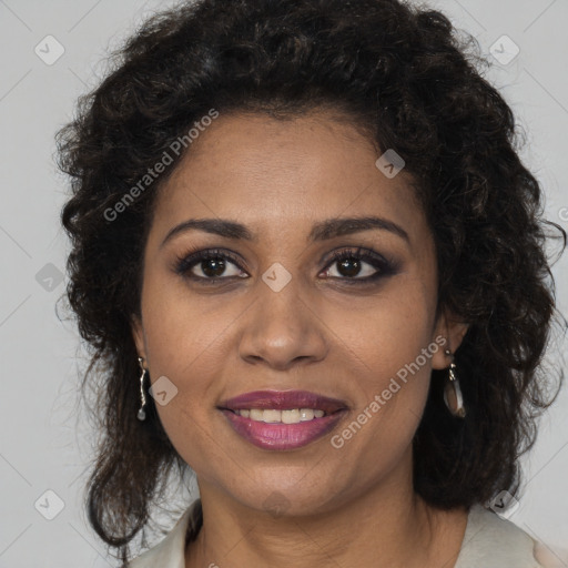 Joyful black adult female with long  brown hair and brown eyes