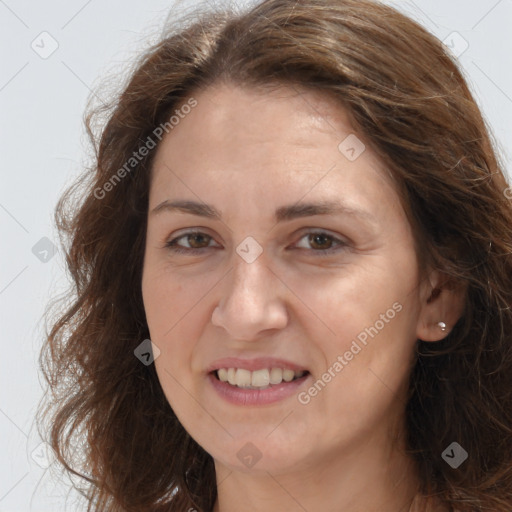 Joyful white adult female with long  brown hair and brown eyes