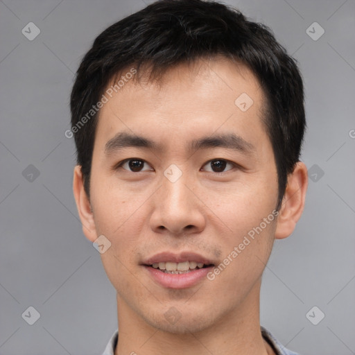 Joyful asian young-adult male with short  black hair and brown eyes