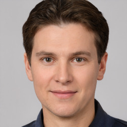 Joyful white young-adult male with short  brown hair and grey eyes