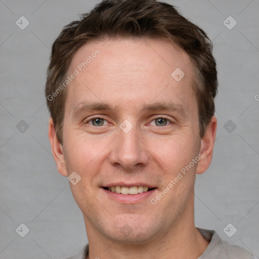 Joyful white adult male with short  brown hair and grey eyes