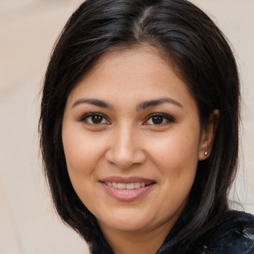 Joyful latino young-adult female with medium  brown hair and brown eyes