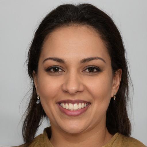 Joyful latino young-adult female with medium  brown hair and brown eyes