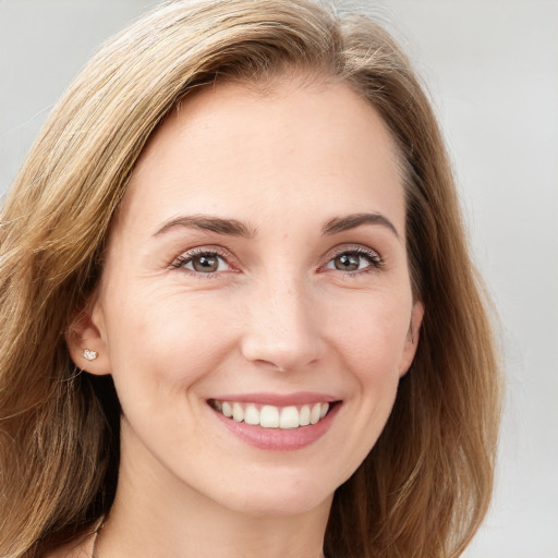 Joyful white young-adult female with long  brown hair and brown eyes