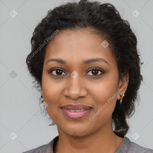 Joyful black young-adult female with long  black hair and brown eyes