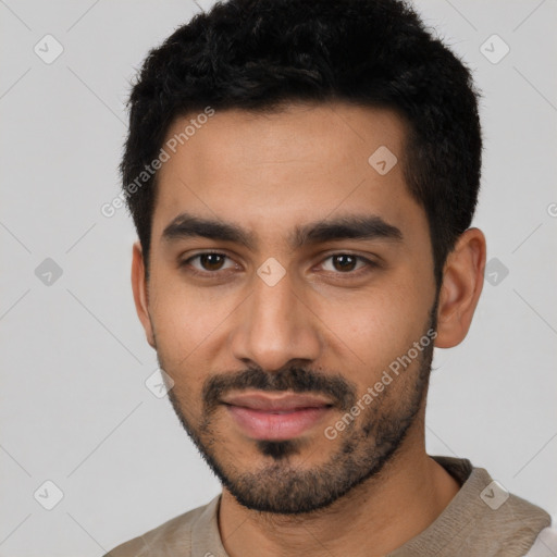 Joyful latino young-adult male with short  black hair and brown eyes