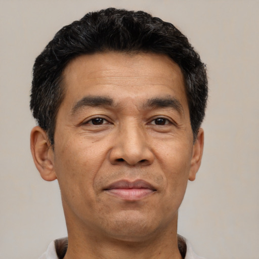 Joyful asian adult male with short  black hair and brown eyes