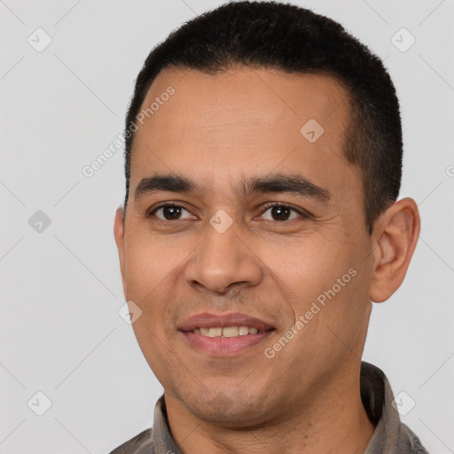 Joyful latino young-adult male with short  black hair and brown eyes