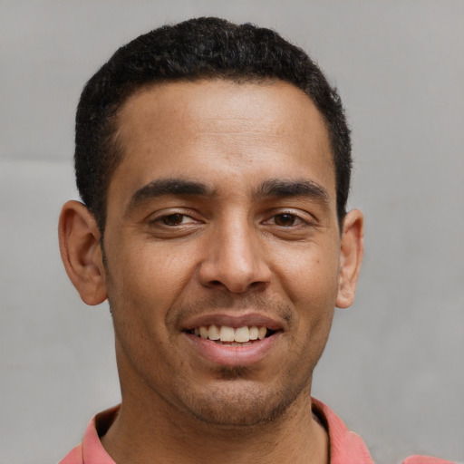 Joyful latino young-adult male with short  brown hair and brown eyes