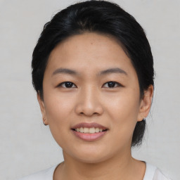 Joyful asian young-adult female with short  black hair and brown eyes