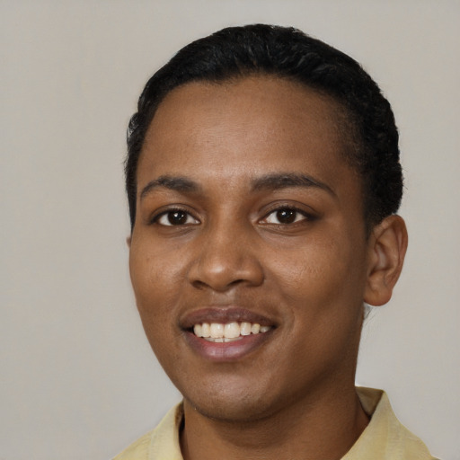 Joyful black young-adult female with short  black hair and brown eyes