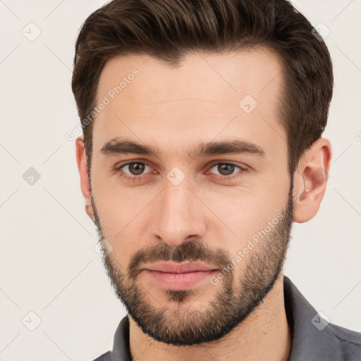 Joyful white young-adult male with short  brown hair and brown eyes