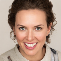 Joyful white young-adult female with medium  brown hair and blue eyes