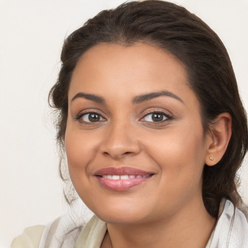 Joyful latino young-adult female with long  brown hair and brown eyes