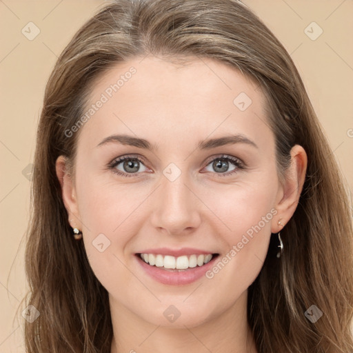 Joyful white young-adult female with long  brown hair and blue eyes