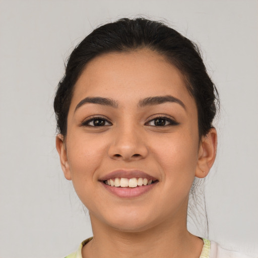 Joyful latino young-adult female with medium  brown hair and brown eyes