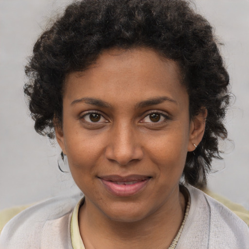 Joyful black young-adult female with short  brown hair and brown eyes
