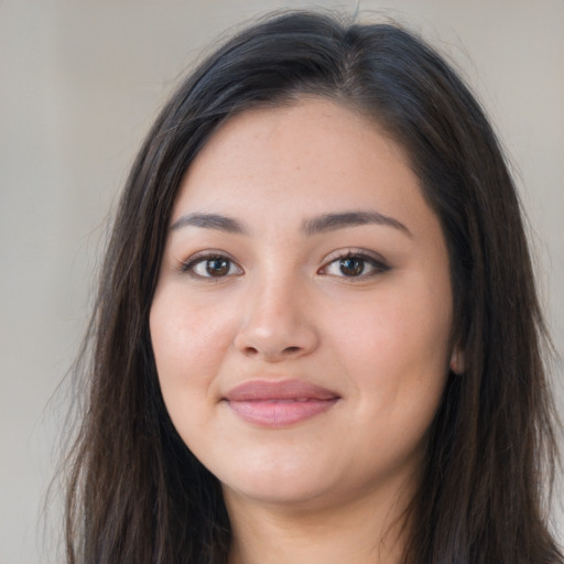 Joyful latino young-adult female with long  brown hair and brown eyes