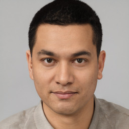 Joyful white young-adult male with short  black hair and brown eyes