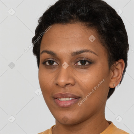 Joyful black young-adult female with short  brown hair and brown eyes