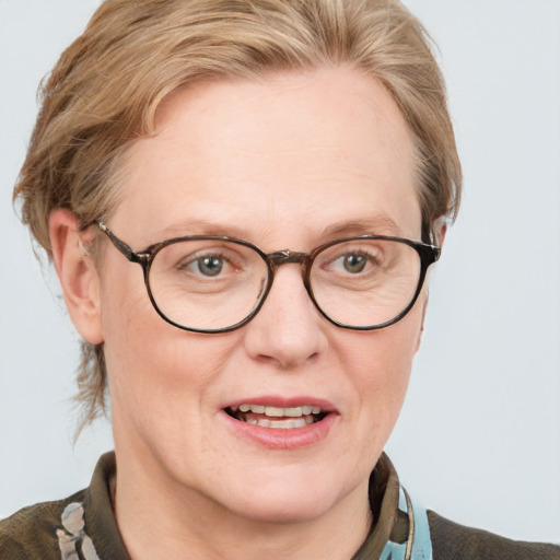 Joyful white adult female with medium  brown hair and blue eyes