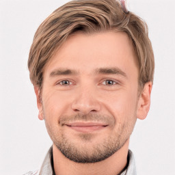 Joyful white young-adult male with short  brown hair and grey eyes