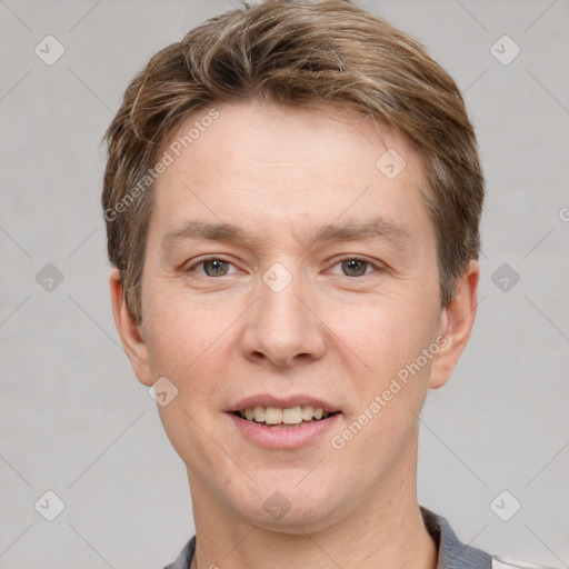 Joyful white young-adult male with short  brown hair and grey eyes