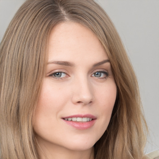 Joyful white young-adult female with long  brown hair and grey eyes