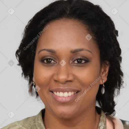 Joyful black adult female with medium  brown hair and brown eyes