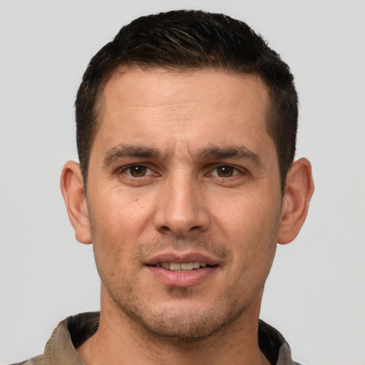 Joyful white young-adult male with short  brown hair and brown eyes