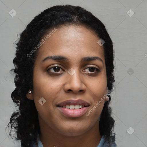 Joyful black young-adult female with long  black hair and brown eyes