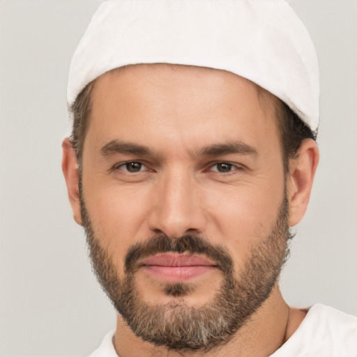 Joyful white adult male with short  black hair and brown eyes