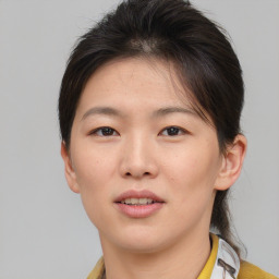 Joyful asian young-adult female with short  brown hair and brown eyes