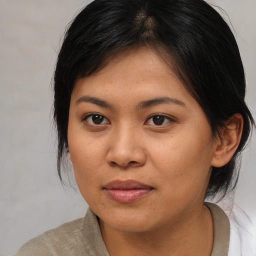 Joyful asian young-adult female with medium  brown hair and brown eyes