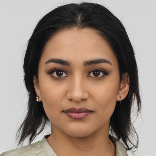 Joyful latino young-adult female with medium  black hair and brown eyes