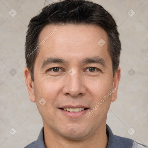 Joyful white adult male with short  brown hair and brown eyes