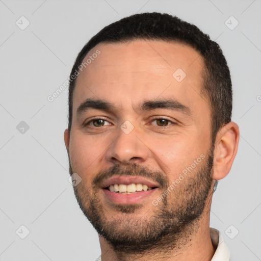 Joyful white young-adult male with short  black hair and brown eyes