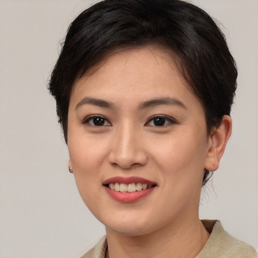 Joyful asian young-adult female with medium  brown hair and brown eyes