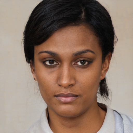 Neutral black young-adult female with medium  black hair and brown eyes