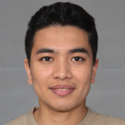 Joyful asian young-adult male with short  black hair and brown eyes