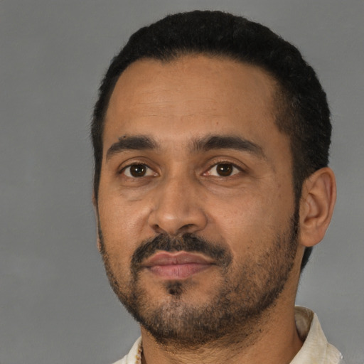 Neutral latino young-adult male with short  black hair and brown eyes