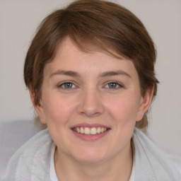 Joyful white young-adult female with medium  brown hair and blue eyes