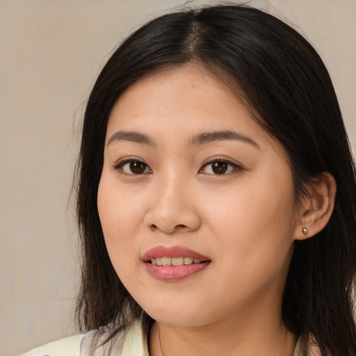 Joyful asian young-adult female with medium  brown hair and brown eyes