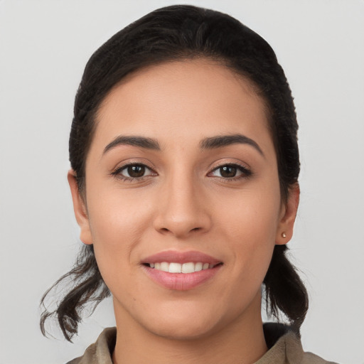 Joyful white young-adult female with long  black hair and brown eyes