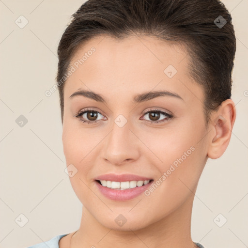 Joyful white young-adult female with short  brown hair and brown eyes