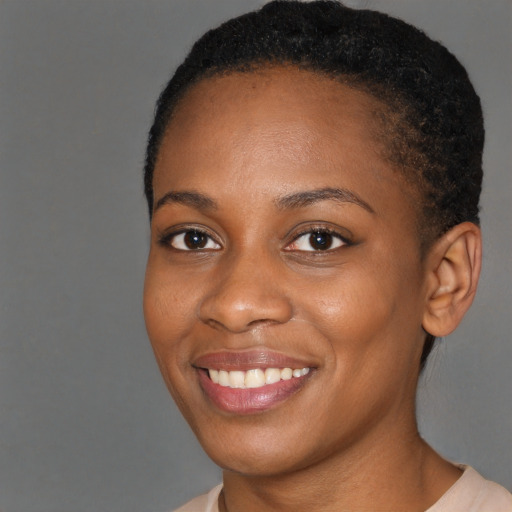 Joyful black young-adult female with short  brown hair and brown eyes