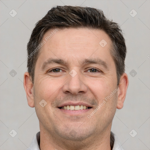 Joyful white adult male with short  brown hair and brown eyes