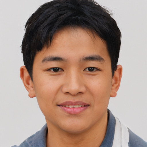 Joyful asian young-adult male with short  brown hair and brown eyes