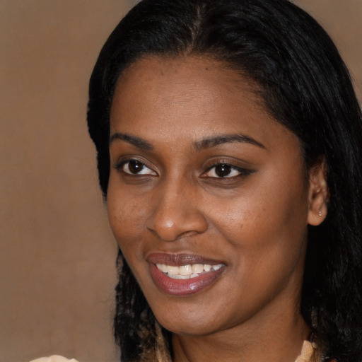 Joyful black young-adult female with medium  brown hair and brown eyes